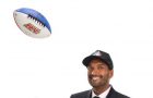 Vivek Jain tossing a football into the air