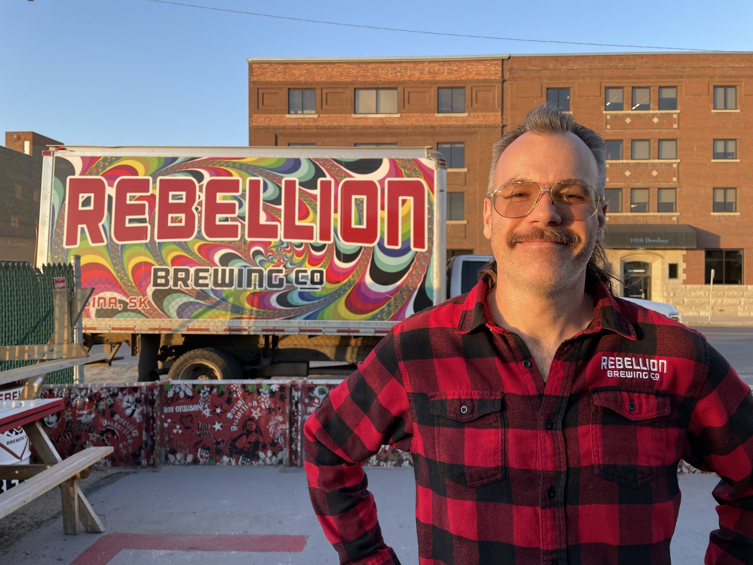 pic of Heise in front of Rebellion delivery truck