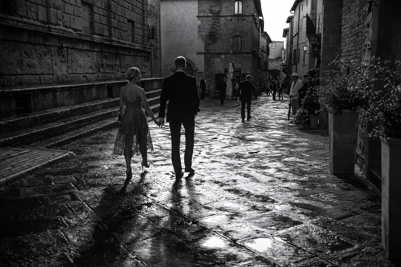 <small>A couple walks down a street after a posh wedding in Pienza, Tuscany</small>