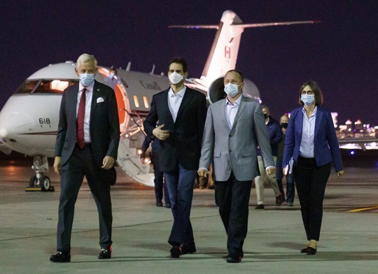 France Viens (right) and Canadian Ambassador to the People's Republic of China, Domimic Barton (left), land in Calgary on September 25, 2021. Viens and Barton were escorting Michael Kovrig (second from left) and Michael Spavor back to Canada after they spent almost three years being detained by Chinese officials.  