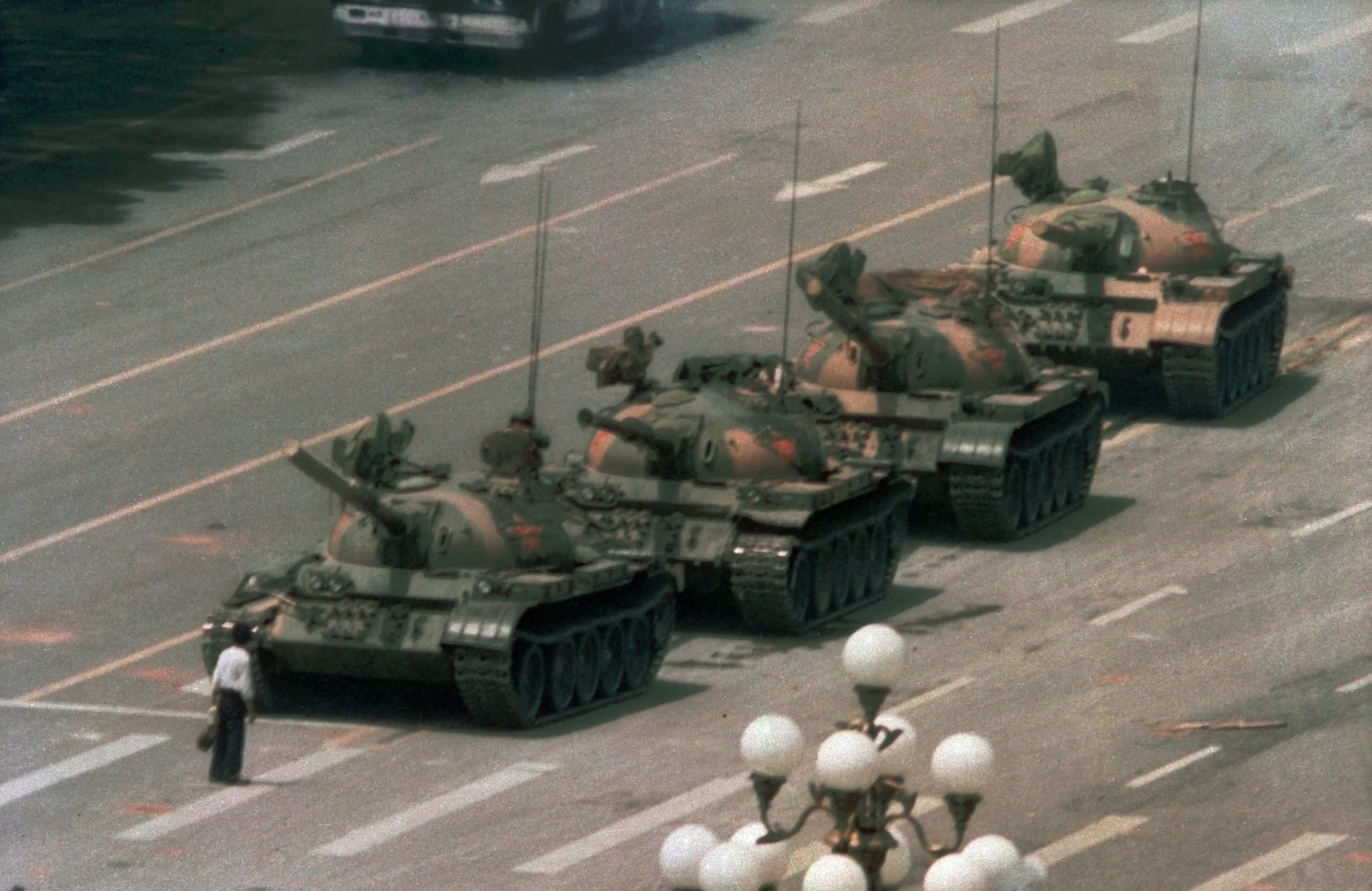 In this June 5, 1989, file photo, a Chinese man stands alone to block a line of tanks heading east on Beijing's Changan Blvd. in Tiananmen Square.  Photo by AP Photo/Jeff Widener