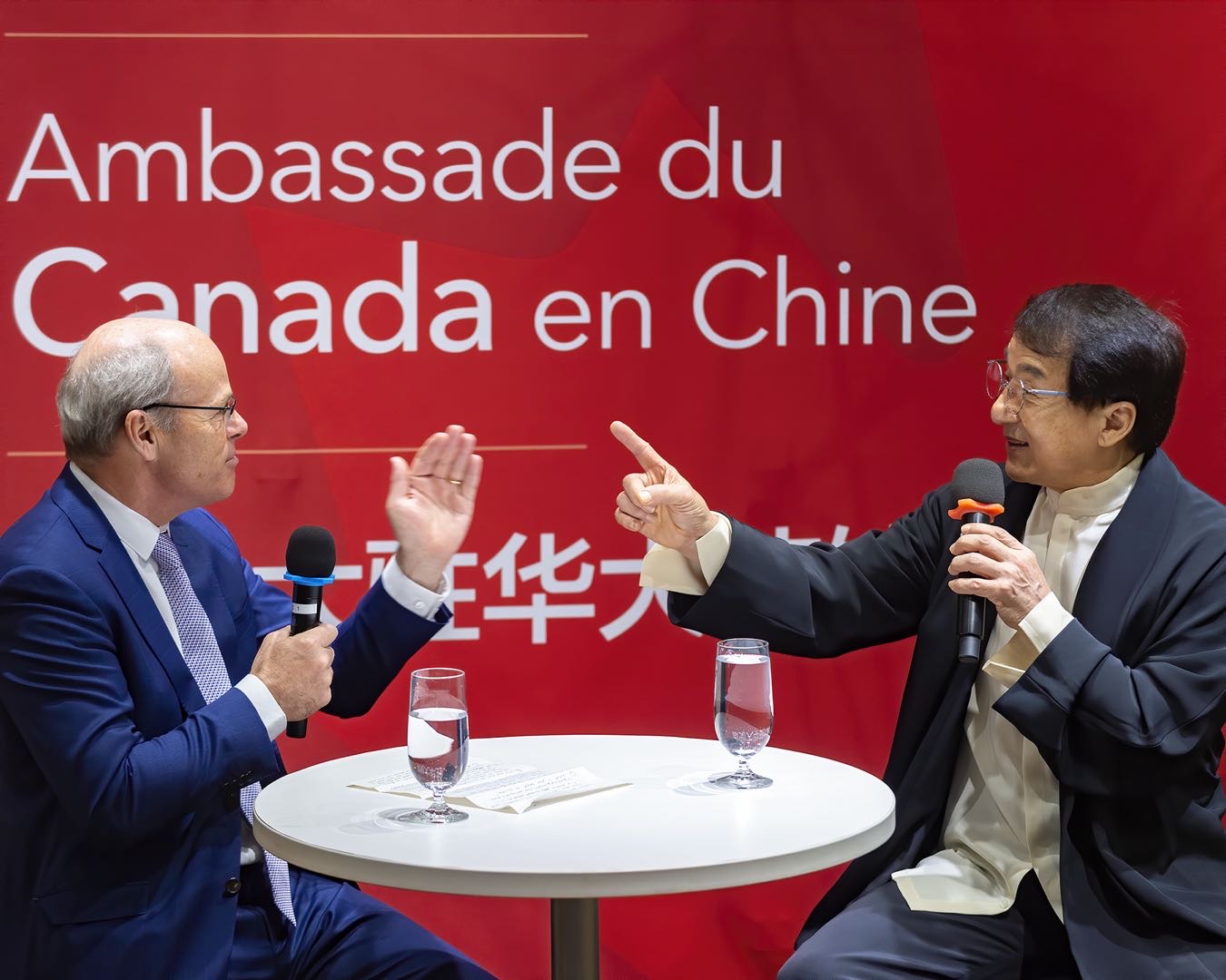 Nickel interviews (and maybe delivers a karate chop to action adventure star Jackie Chan at the Canadian Embassy in Beijing in December 2021.