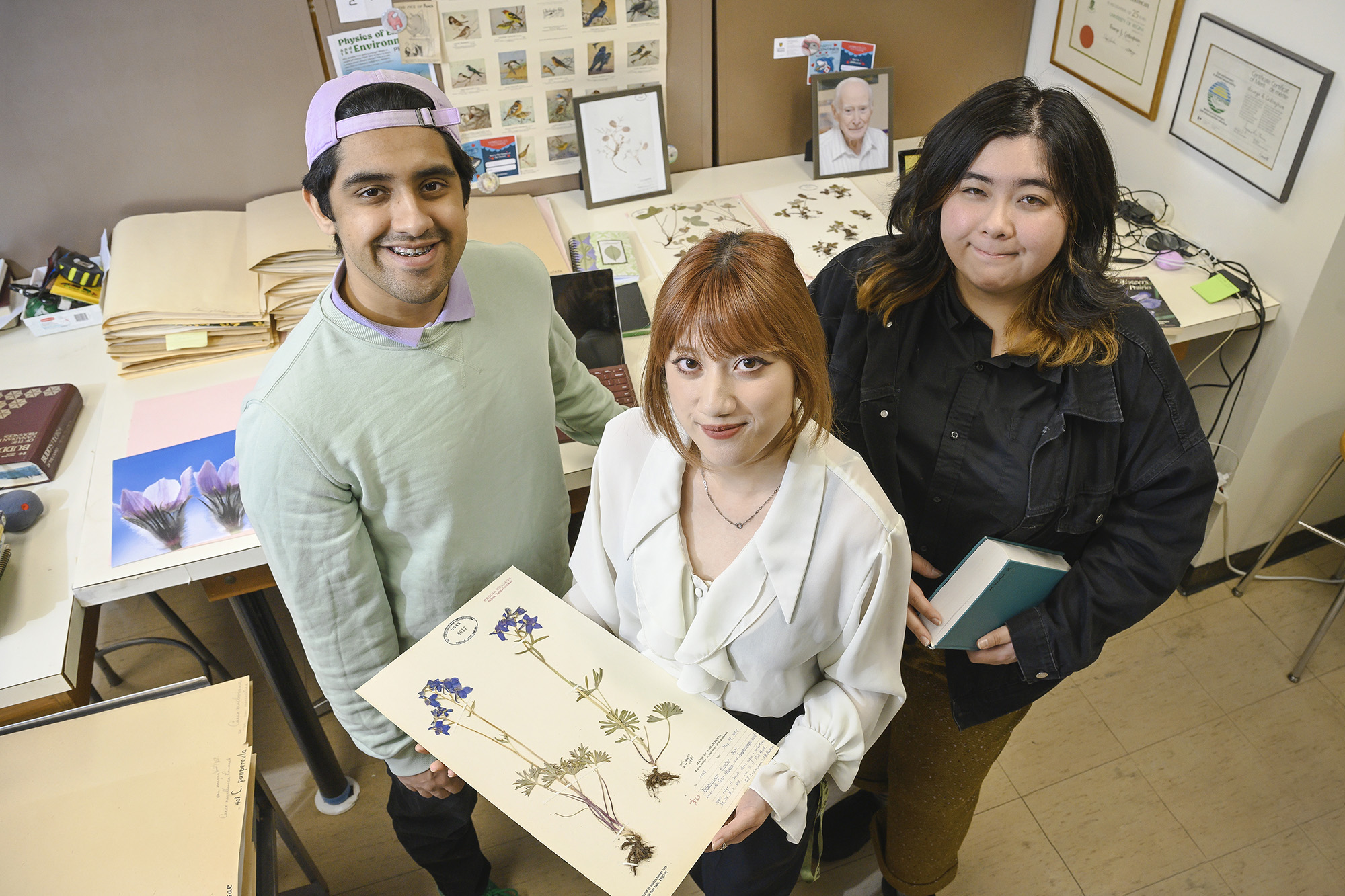Three students pose in the U of R herbarium.