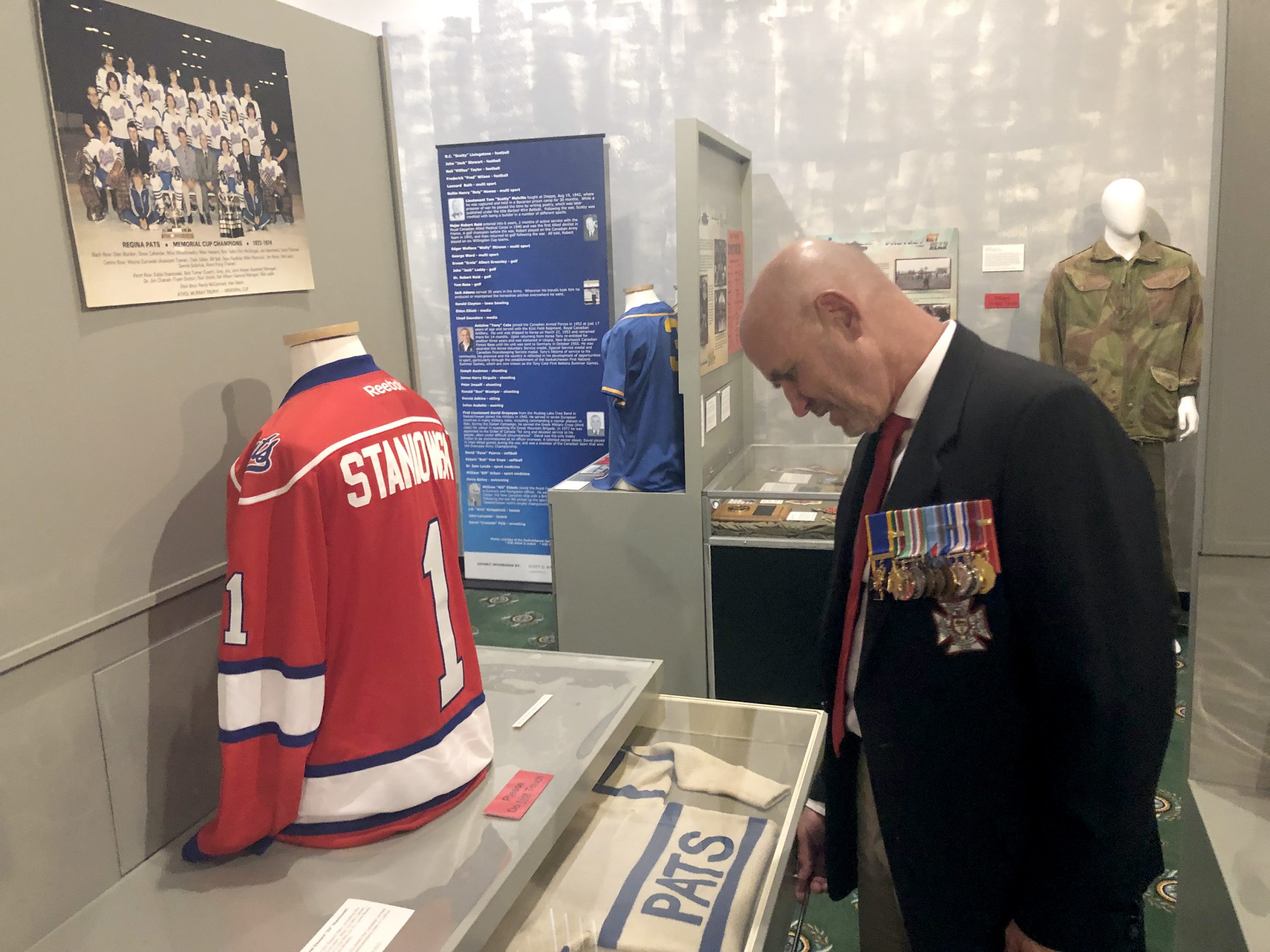 Retired Lieutenant-Colonel Ed Staniowski, the man behind the commemoration project. Staniowski is seen here looking at some of his hockey memorabilia from a display at the Saskatchewan Sports Hall of Fame. Photo courtesy of  Saskatchewan Sports Hall of Fame