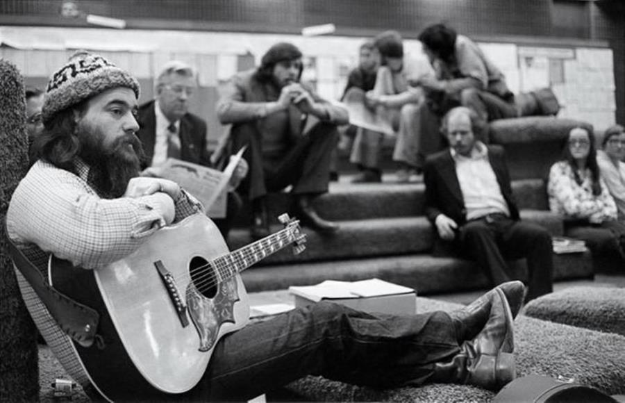 Archival black and white image of individuals in conversation pit