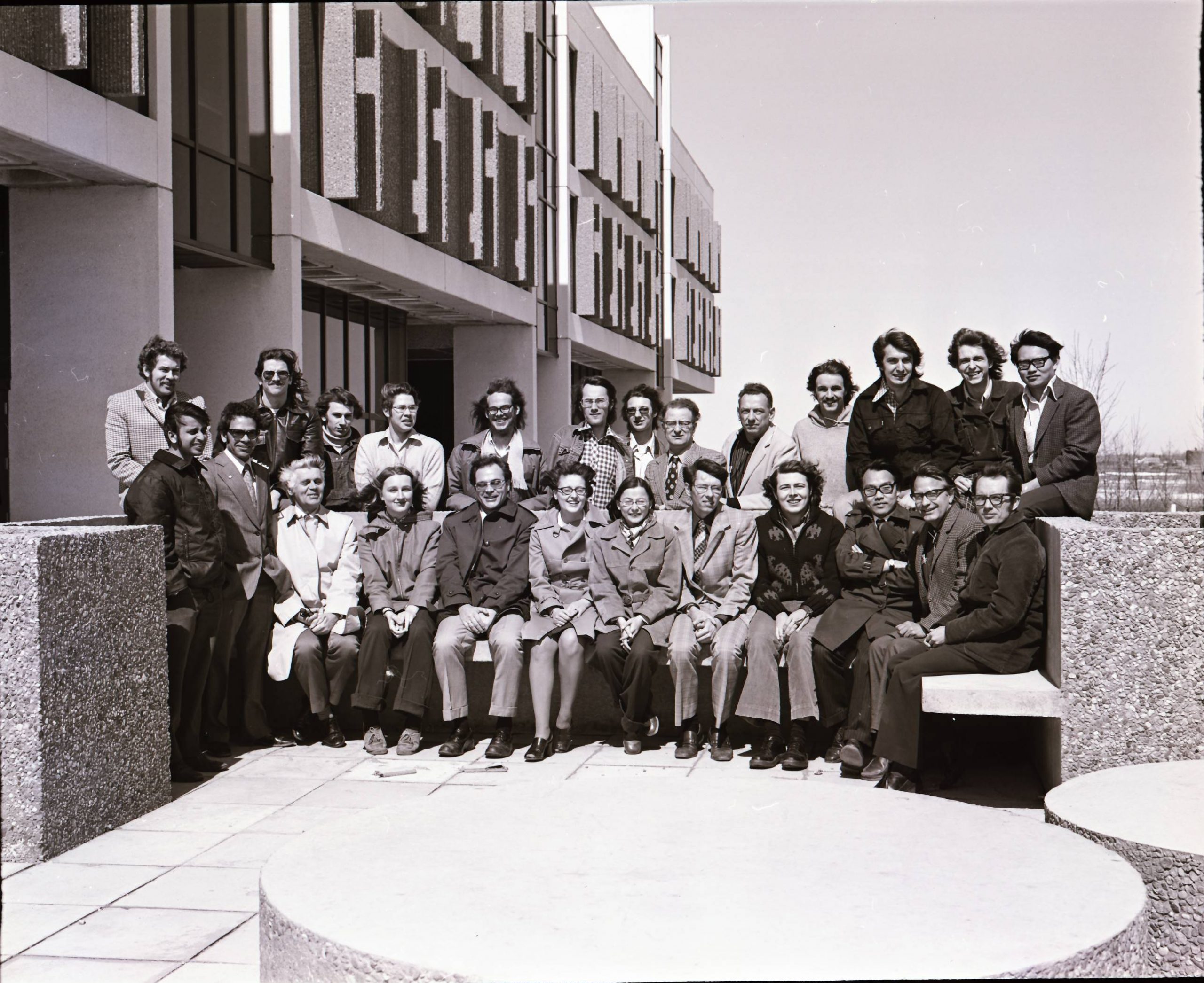Archvial black and white photo of student outside the classroom building in 1974.