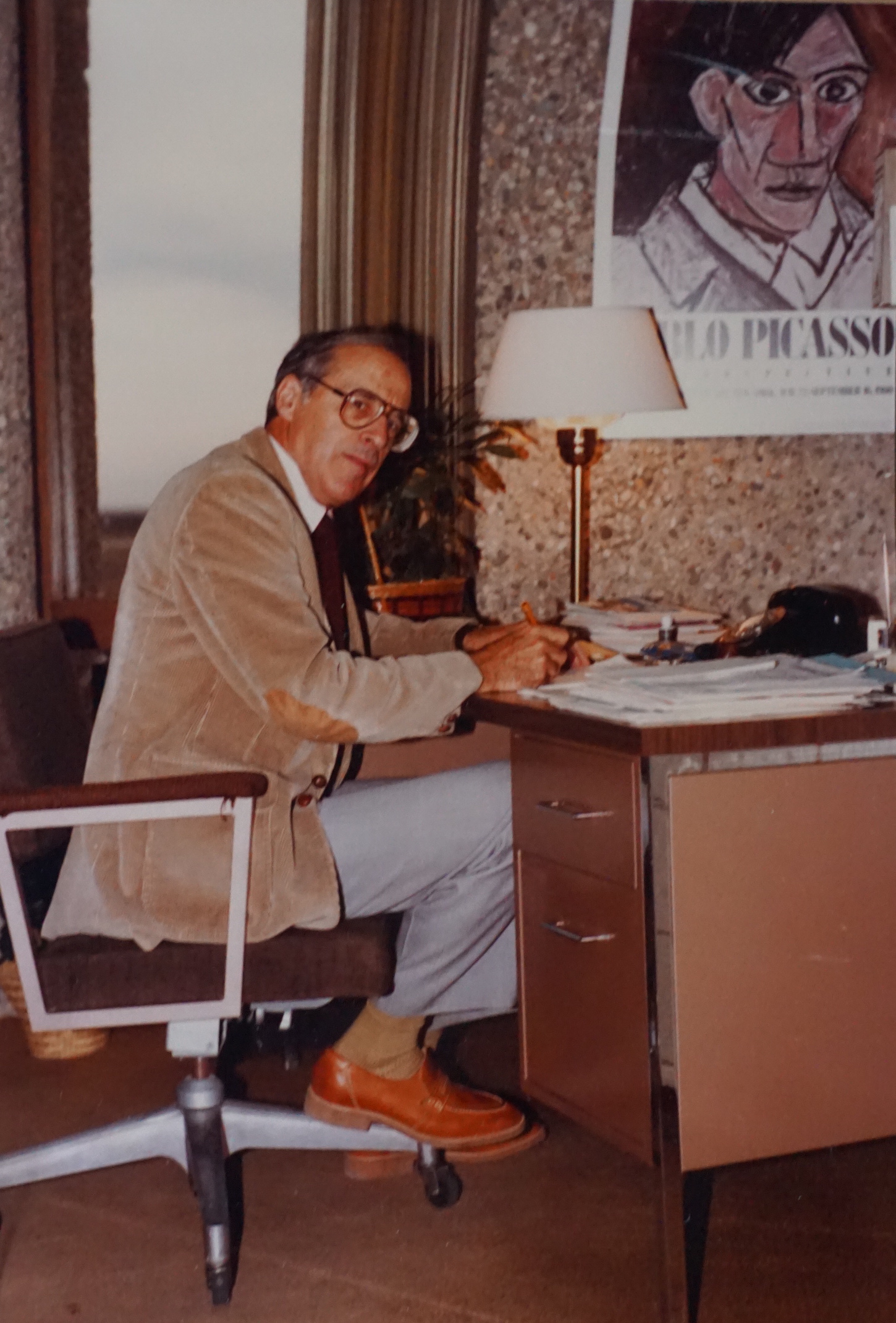 Bernard in office at Library Building Individual at desk in the 1970s