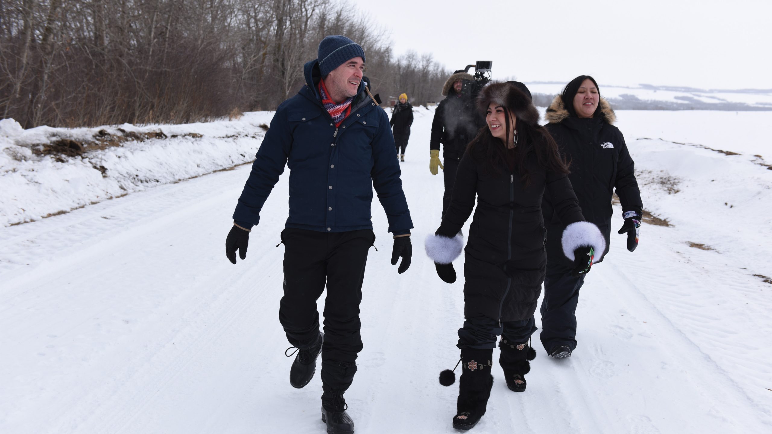 Four individuals in a snowy location