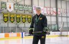 Smiling individual at hockey rink.