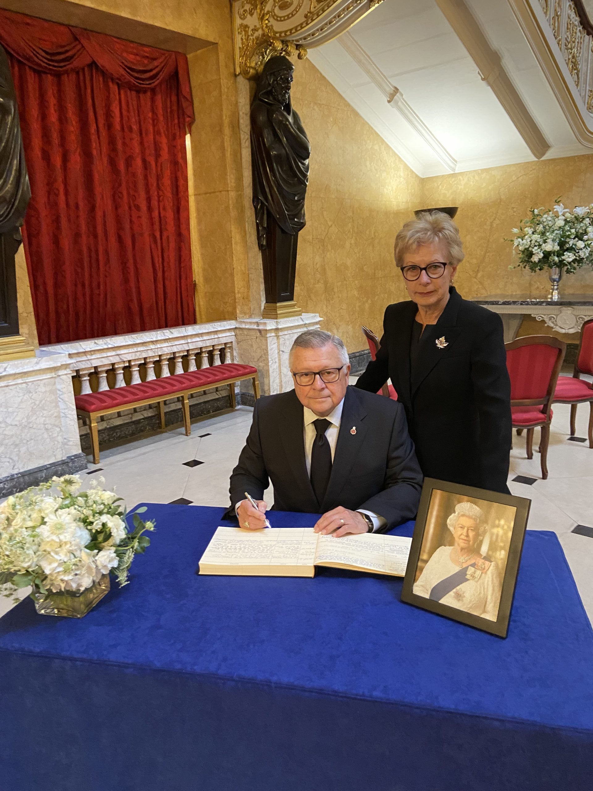Ralph and Pamela Goodale signing the Book of Condolences for Her Late Majesty, Queen Elizabeth II.