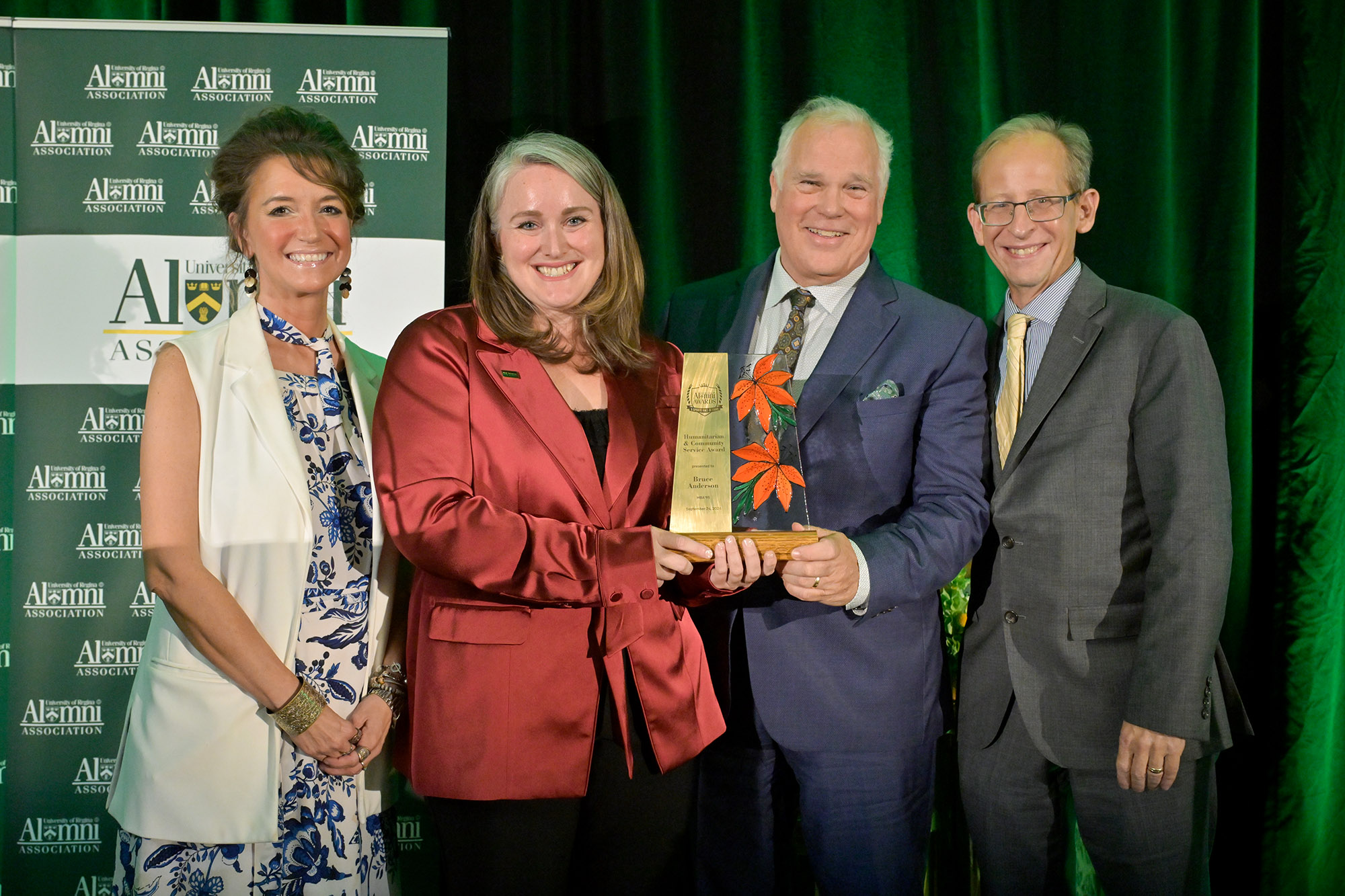 Bruce Anderson MBA'95 (centre) accepts Humanitarian & Community Service Award, pictured with (l-r) Jennifer Murray, President, URAA; Dr. Erin Oldfor, Dean, Hill Levene School of Business; Dr. Jeff Keshen