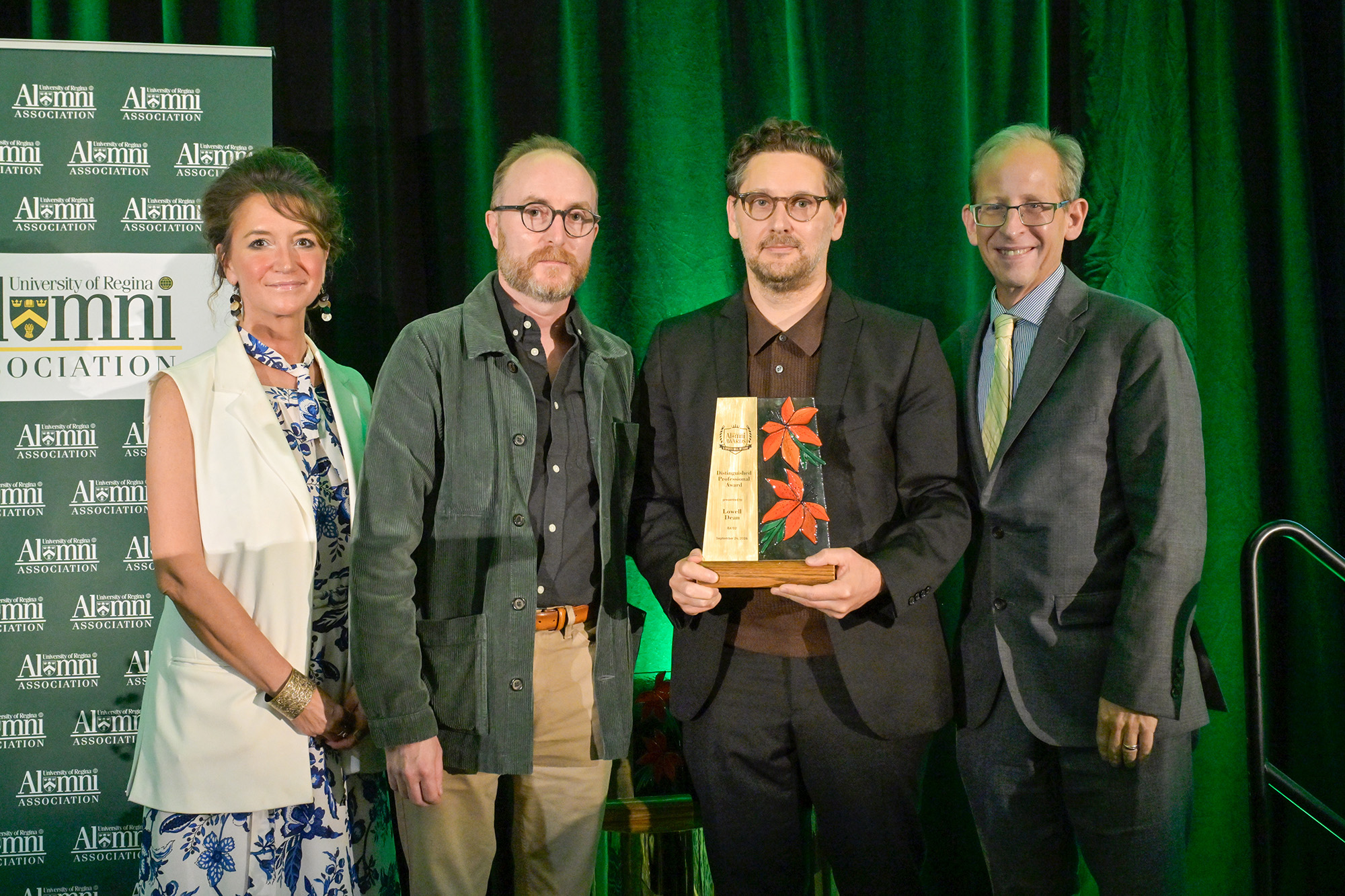 Lowell Dean BA'02 (centre) accepts Distinguished Professional Award pictured with (l-r) Jennifer Murray, President, URAA; Mike Rollo, Department Head, Department of Film; and Dr. Jeff Keshen.