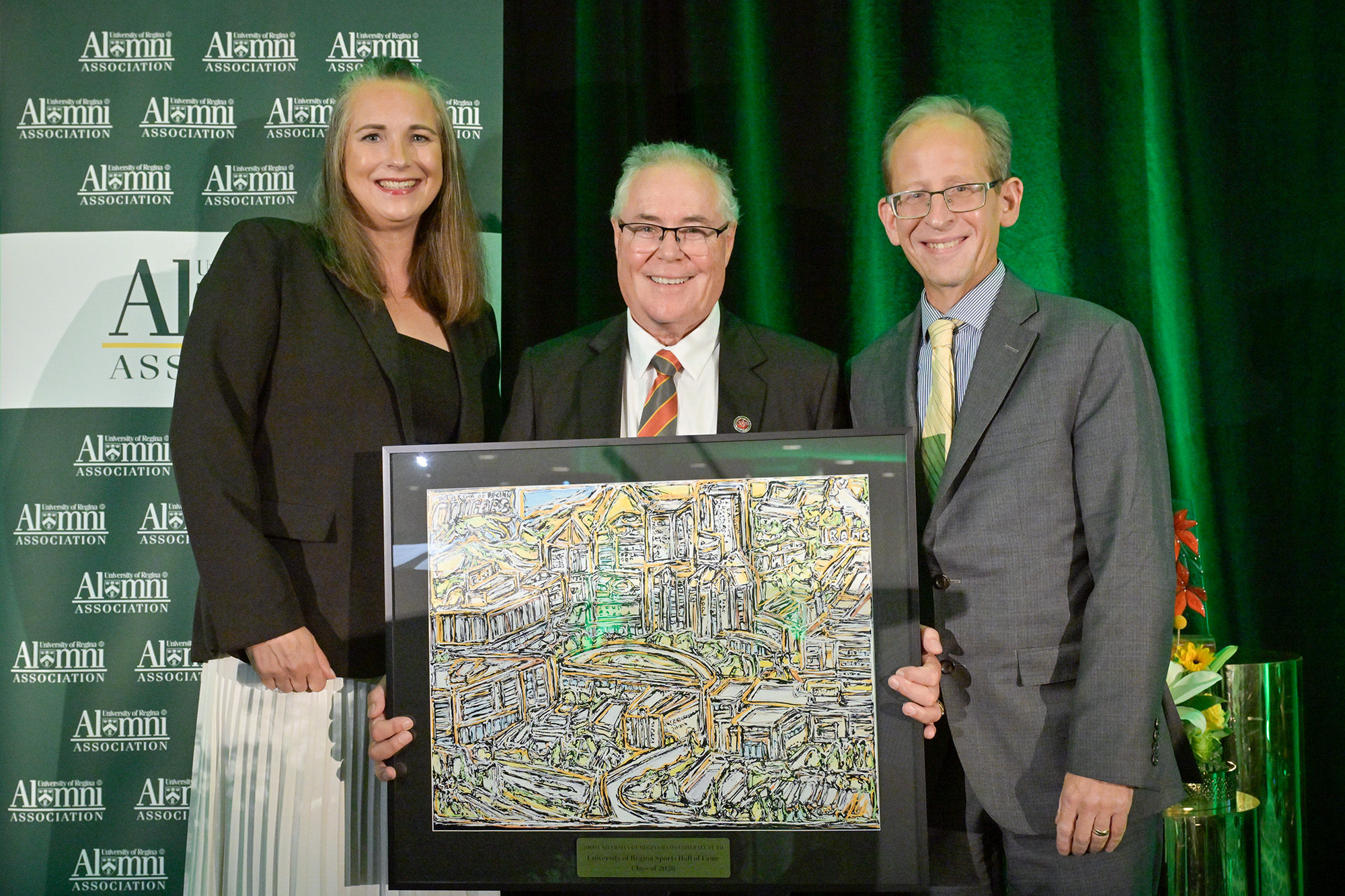 Frank McCrystal, coach, 2000 U of R Rams accepts 2000 Rams' induction to Sports Hall of Fame, pictured with Lisa Robertson and Dr. Jeff Keshen.