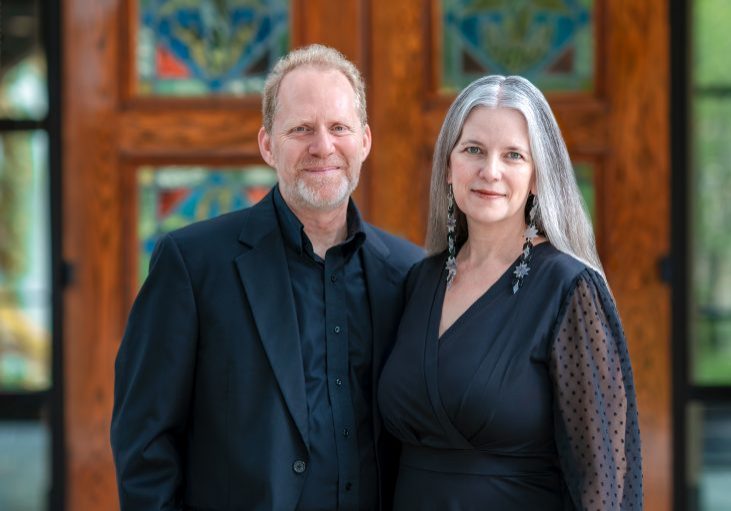 Man and woman standing in front of theatre.